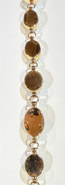 Back of a gold bracelet with opal gemstones on a white background