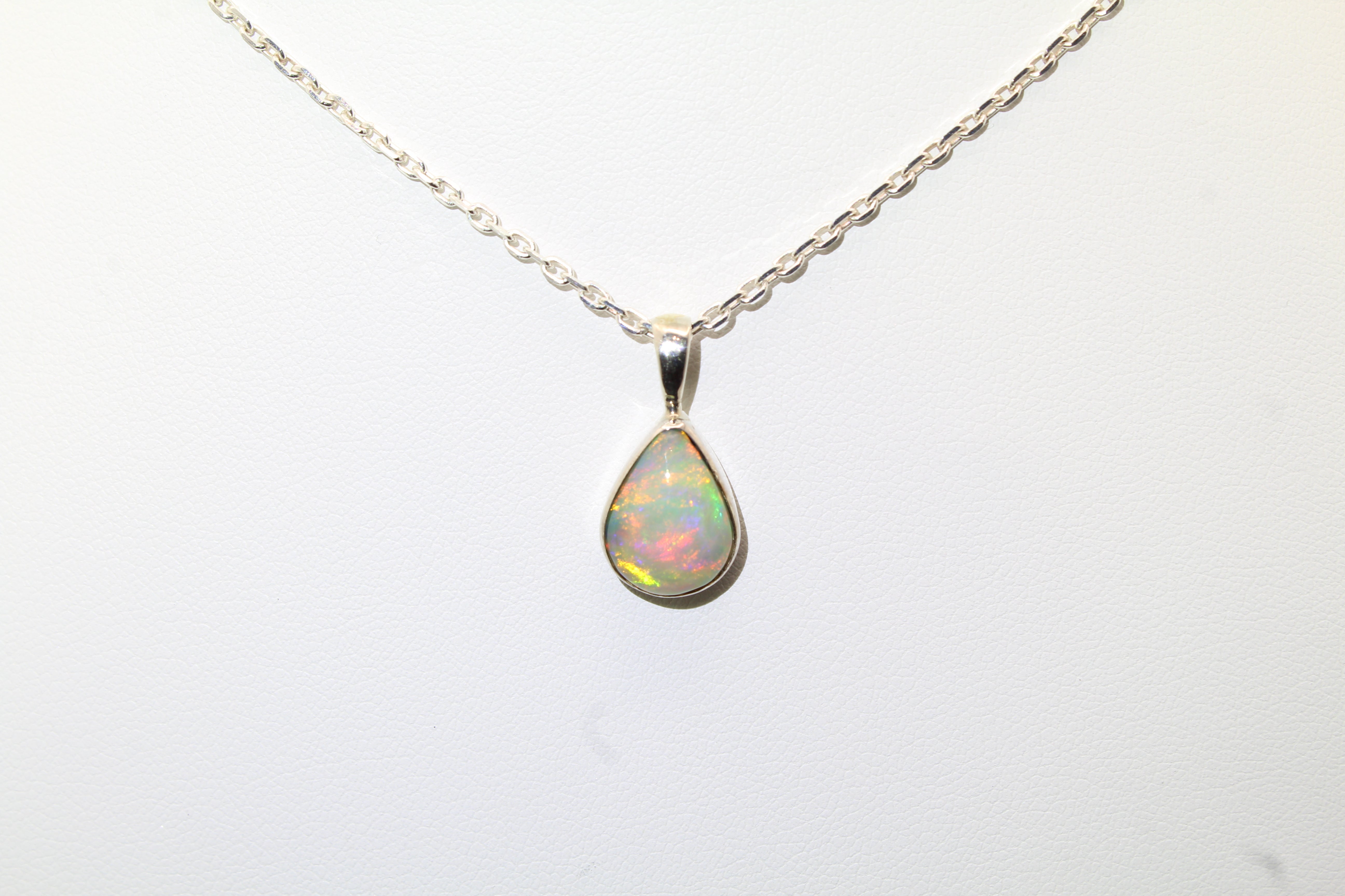Opal pendant necklace on a white background