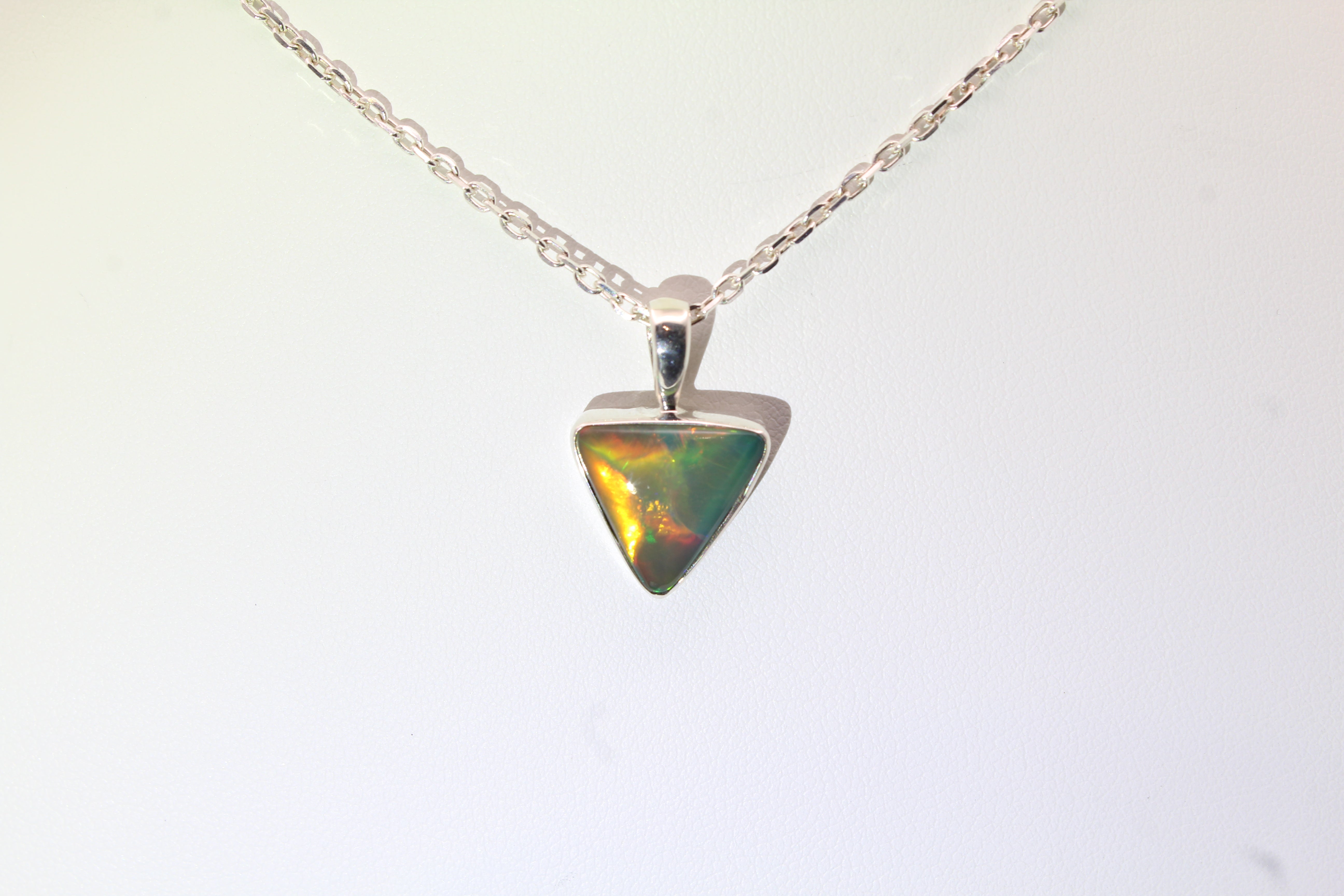Opal pendant necklace on a white background